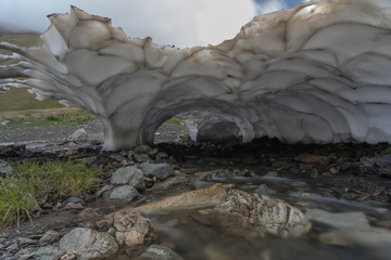 The foot of the glacier melting with a stream