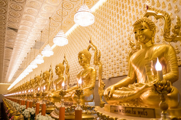 Thai Golden Buddha statue. Row of golden buddha statue. Thai Golden Buddha statue. Buddha image in the middle. Statue of Buddha sitting in meditation.