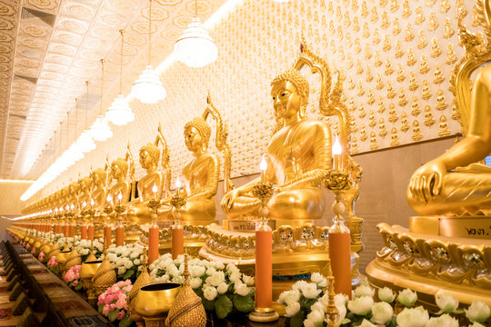 Thai Golden Buddha statue. Row of golden buddha statue. Thai Golden Buddha statue. Buddha image in the middle. Statue of Buddha sitting in meditation.