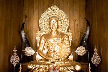 Thai Golden Buddha statue. Buddha image in the middle. Statue of Buddha sitting in meditation.