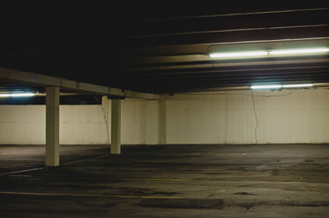 Down under the dim and dark parking garage in the back alley of the city. 