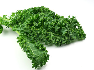 Fototapeta premium Green kale leaves, one of the super foods, isolated on a white background, beneficial for health lovers. High in antioxidants