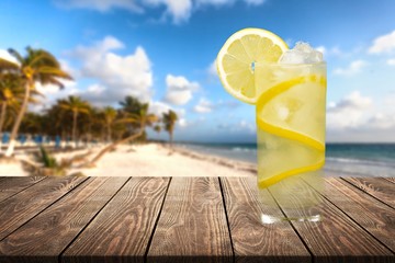 Lemonade with fresh sliced lemon on desk
