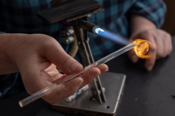 Woman  making glass bead