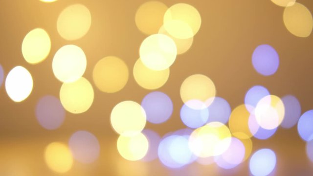 Abstract warm yellow bokeh background in 4K.