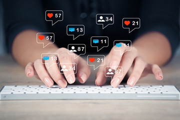 hands typing on computer blue tone