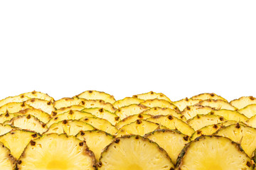 Pineapple juicy yellow slices background. Top view.