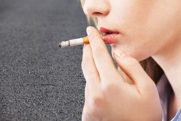 Woman holds cigarettes, bad habits concept