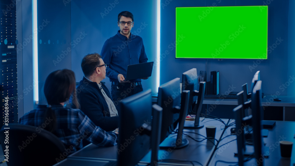 Poster Team of Professional IT Developers Have a Meeting, Speaker Talks about About New Concepts, On Wall TV has Green Mock-up Screen. Concept: Software Development, Deep Learning, Artificial Intelligence