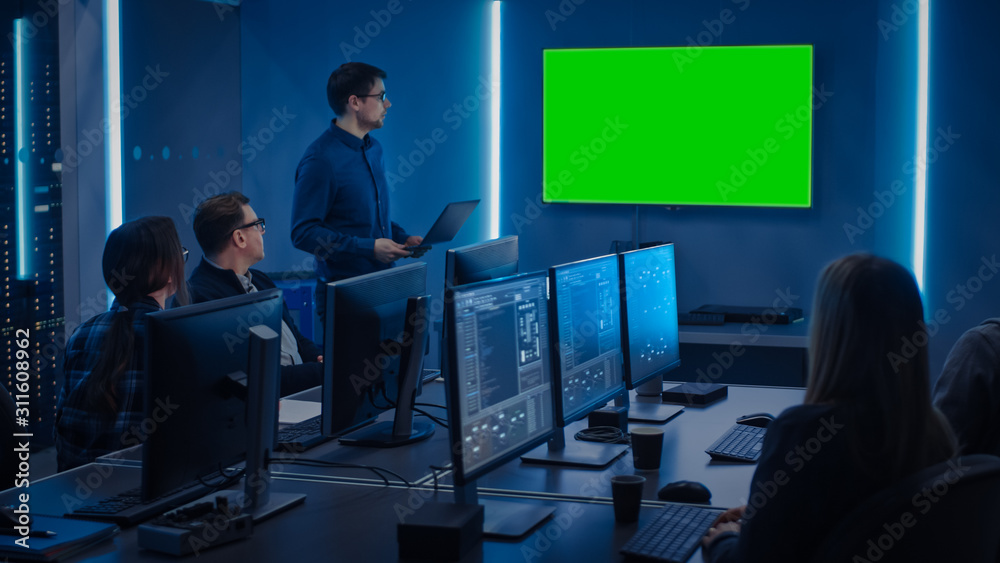 Poster Team of Professional IT Developers Have a Meeting, Speaker Talks about About New Concepts, On Wall TV has Green Mock-up Screen. Concept: Software Development, Deep Learning, Artificial Intelligence