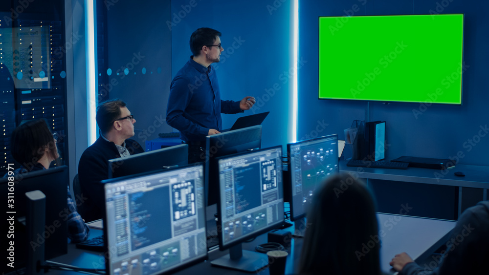 Poster Team of Professional IT Developers Have a Meeting, Speaker Talks about About New Concepts, On Wall TV has Green Mock-up Screen. Concept: Software Development, Deep Learning, Artificial Intelligence