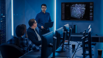 Team of Professional IT Developers Have a Meeting, Speaker Talks about New Blockchain Based Software Development Shown on TV. Concept: Software Development, Deep Learning, Artificial Intelligence