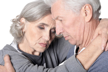 Close up portrait of sad senior couple isolated on white background