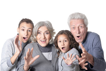 Portrait of happy grandparents with kids isolated on white background