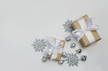 silver decorations and present on a white background