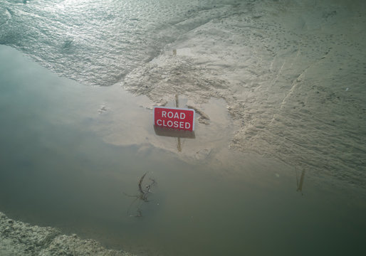 Road closed sign under water