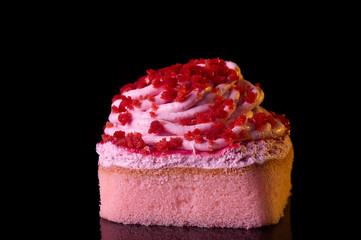 Freshly baked strawberry soft cake with cream and dried berry sprinkle on top