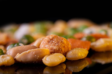 A pile of mixed nuts, healthy snack,  on black background