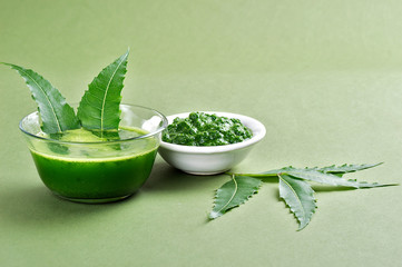 Medicinal Neem leaves paste and juice with leaves on green background