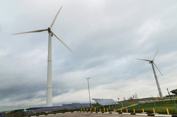 Renewable alternative clean wind energy produced by wind generators helps to preserve The earth's ecology. - 311619349