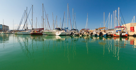 Fototapeta na wymiar Day foto of old venetian harbor with boats in Heraklion