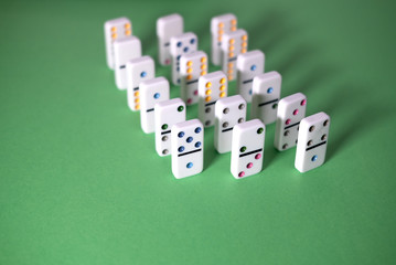 dominoes stand on a green background selective focus