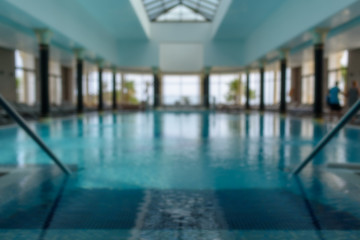 Indoor swimming pool in blurry background. Abstract swimming pool in fitness centre..
