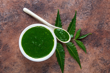 Medicinal Neem leaves with paste on stone background