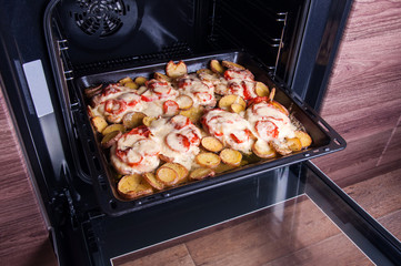Pork meat with vegetables cooked in the oven. Home kitchen