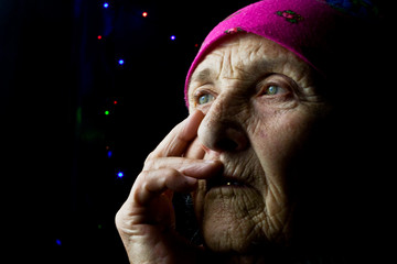 Pensive old grandmother. Portrait photo of an old grandmother. Grandmother's face close up