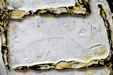 Fragment of an ancient relief with symbols - white and gold. Handwork, ancient art.