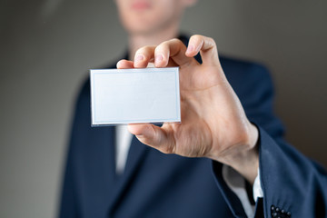 businessman holding an empty badge with copy space mockup, authorization and identification