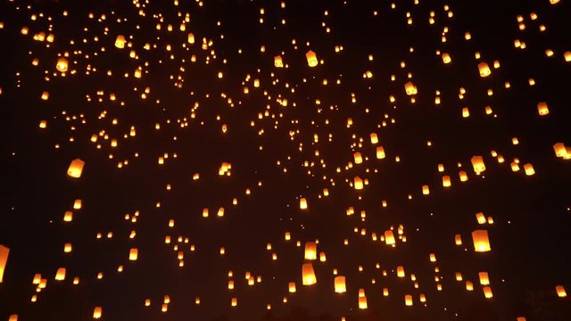 Thai people release sky floating lanterns or lamp to worship Buddha's relics at night. Traditional festival in Chiang mai, Thailand. Loy krathong and Yi Peng Lanna ceremony. Celebration background.