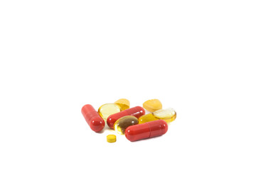 A pile of multi-colored pills, vitamin and tablets isolated on white background