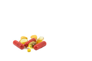 A pile of multi-colored pills, vitamin and tablets isolated on white background