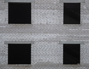 Background from an unfinished building with window openings, from cinder block and floor slabs.