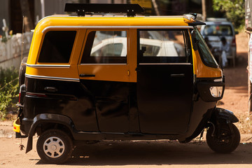 Fototapeta premium Tuk-tuk. side view. Taxi in India and Sri-lanka. Type of transport in Asia. 