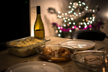 Christmas dinner, wine with lights bokeh. Greeting card for new year party. Festive holiday