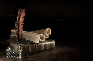 Fototapeta Quill pen and a rolled papyrus sheet with old books, vintage effect obraz