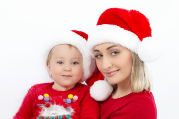 Portrait of mother and daughter in Christmas hats Santa Claus on a white background. Close up. The concept of happy childhood and family happiness.