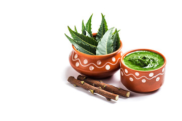 Medicinal Neem leaves with paste and twigs on white background