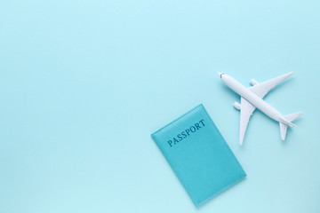 Airplane model with passport on blue background