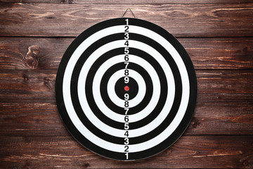 Dartboard on brown wooden table