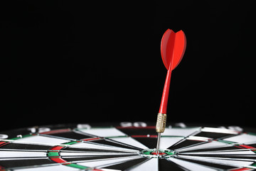 Fototapeta premium Dartboard with darts on black background