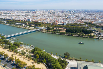 Naklejka premium The ship goes on the river of the city of Seville