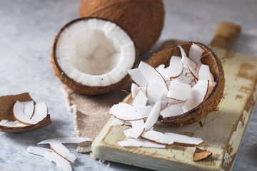 Cracked fresh coconut  and slice nut on concrete background, space for text Food ingredients,...