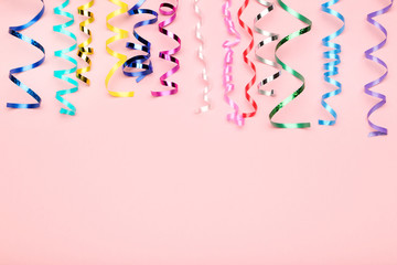 Colorful ribbons on pink background