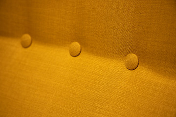 Fabric Texture, Close Up of Yellow Textile Pattern Background with Round Buttons.