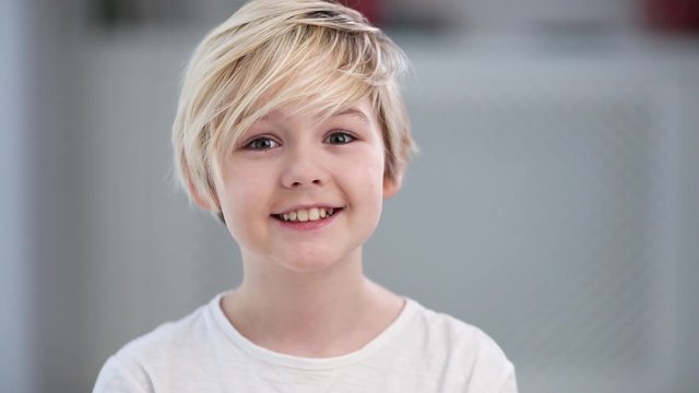 portrait of cute young blonde boy, smiling kid