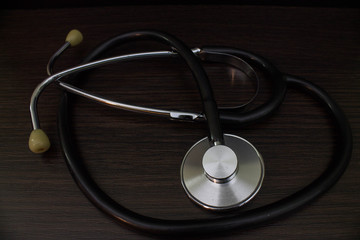 Stethoscope - a medical diagnostic device for auscultation (listening) of sounds coming from the heart, blood vessels, lungs, bronchi, intestines and other organs on a dark background
